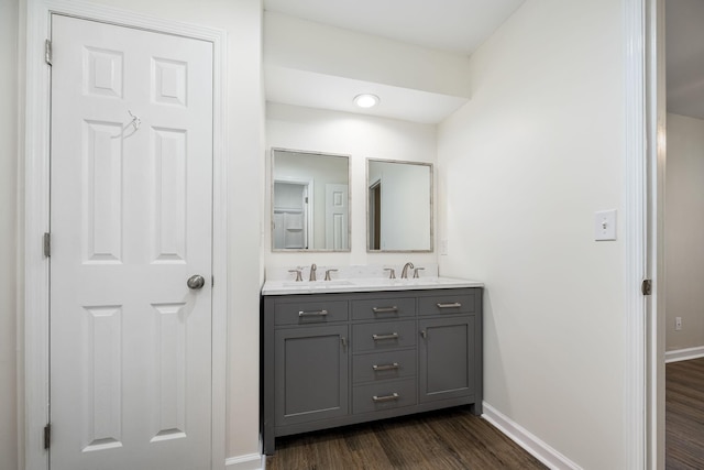 205 Blue Lake Dr, Tullahoma, TN 37388 - bathroom featuring baseboards, wood finished floors, and double vanity