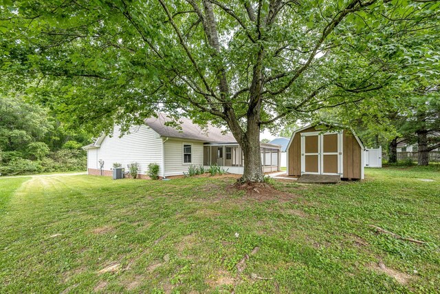 205 Blue Lake Dr, Tullahoma, TN 37388 - back of property featuring a storage shed, an outdoor structure, and central AC unit