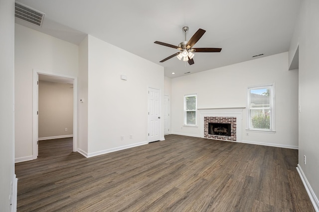 205 Blue Lake Dr, Tullahoma, TN 37388 - unfurnished living room with dark wood-style flooring, a ceiling fan, baseboards, and a brick fireplace