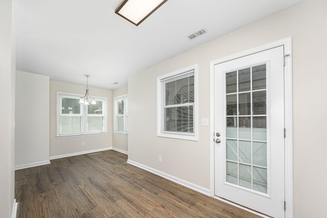 205 Blue Lake Dr, Tullahoma, TN 37388 - unfurnished room featuring dark wood-style flooring, a chandelier, and baseboards