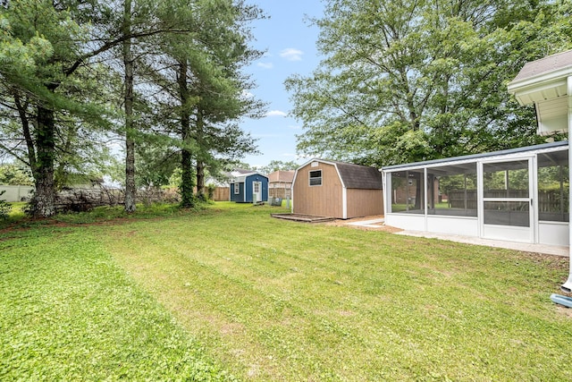 205 Blue Lake Dr, Tullahoma, TN 37388 - view of yard featuring a shed, a sunroom, and an outbuilding
