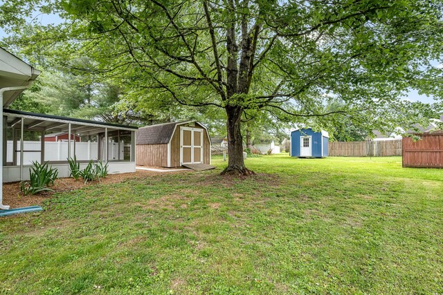 205 Blue Lake Dr, Tullahoma, TN 37388 - view of yard featuring a shed, an outbuilding, and a sunroom