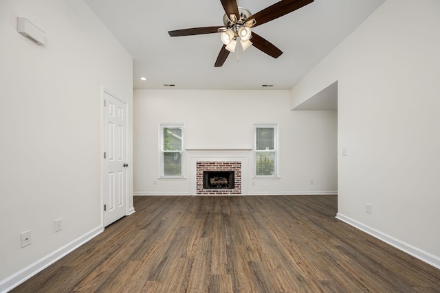 205 Blue Lake Dr, Tullahoma, TN 37388 - unfurnished living room featuring dark wood-type flooring, ceiling fan, baseboards, recessed lighting, and a brick fireplace