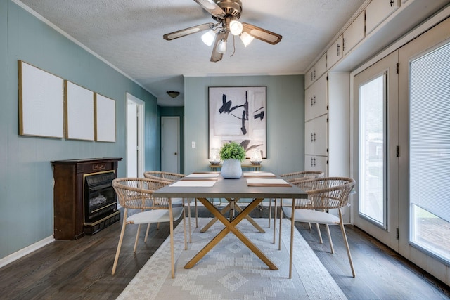 1529 W Grab Creek Rd, Dickson, TN 37055 - dining area with wood finished floors, a textured ceiling, a glass covered fireplace, baseboards, and a ceiling fan
