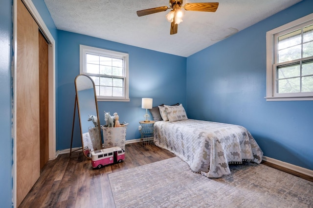 1529 W Grab Creek Rd, Dickson, TN 37055 - bedroom with multiple windows, wood finished floors, a closet, baseboards, and a textured ceiling