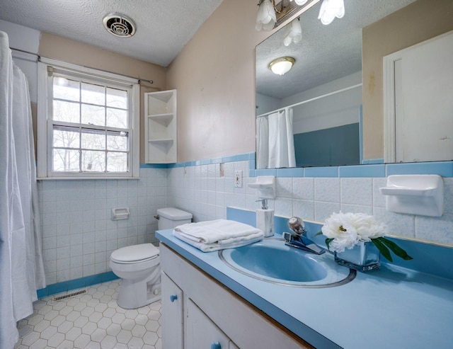 1529 W Grab Creek Rd, Dickson, TN 37055 - full bathroom featuring tile walls, tile patterned flooring, toilet, vanity, and a textured ceiling