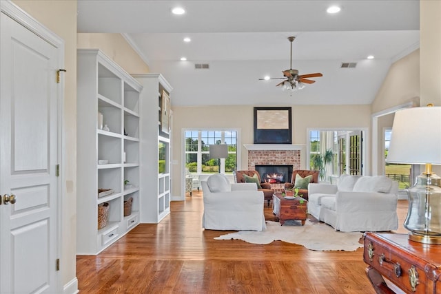 4145 Trinity Rd, Franklin, TN 37067 - living room featuring plenty of natural light, a brick fireplace, wood finished floors, ceiling fan, and vaulted ceiling