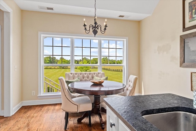 4145 Trinity Rd, Franklin, TN 37067 - dining space with a chandelier, plenty of natural light, wood finished floors, and baseboards