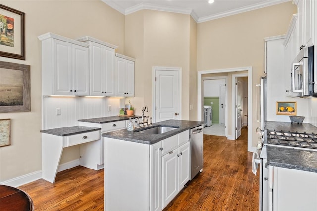 4145 Trinity Rd, Franklin, TN 37067 - kitchen featuring appliances with stainless steel finishes, a sink, white cabinetry, dark wood-style floors, and ornamental molding
