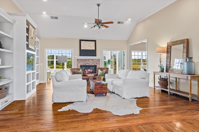 4145 Trinity Rd, Franklin, TN 37067 - living room with a fireplace, ceiling fan, vaulted ceiling, wood finished floors, and built in shelves