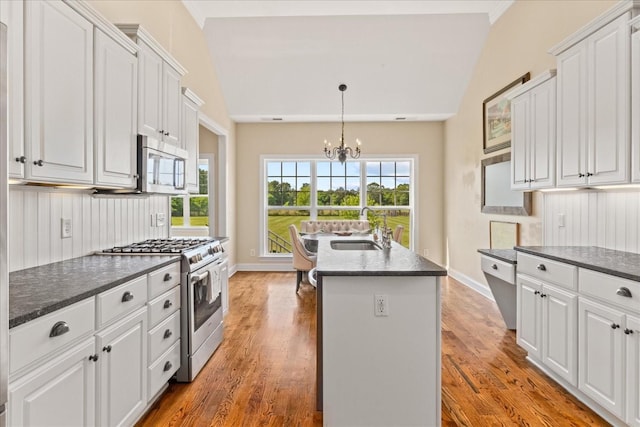 4145 Trinity Rd, Franklin, TN 37067 - kitchen featuring stainless steel appliances, a sink, lofted ceiling, a chandelier, and white cabinets