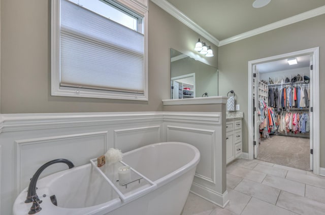1021 Hideaway Rd, Columbia, TN 38401 - full bathroom with a freestanding tub, ornamental molding, vanity, a walk in closet, and tile patterned floors
