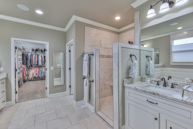 1021 Hideaway Rd, Columbia, TN 38401 - bathroom featuring vanity, ornamental molding, walk in shower, tile patterned flooring, and a walk in closet