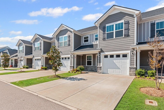 215 Ruth Way, Spring Hill, TN 37174 - townhome / multi-family property featuring an attached garage, driveway, a residential view, and stone siding