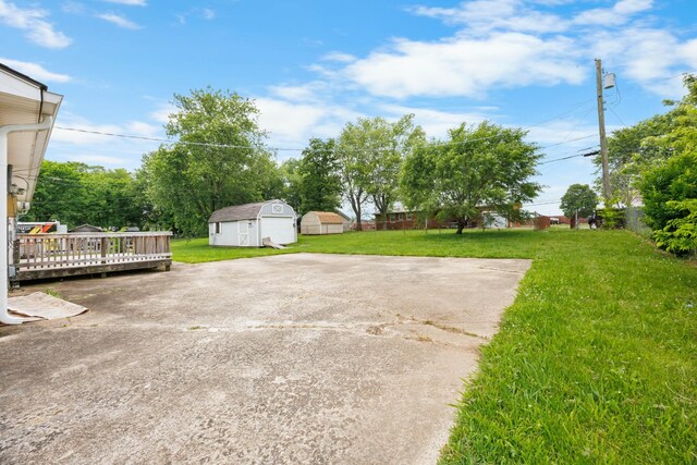 209 Orchard Rd, Clarksville, TN 37042 - view of grassy yard with an outdoor structure, a deck, and a storage unit