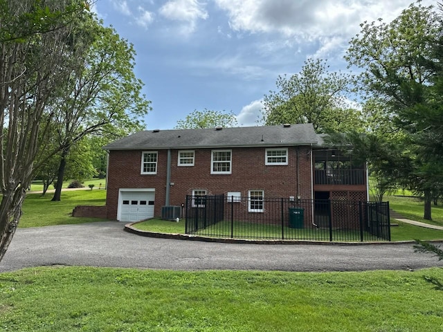 108 Sunset Dr, Pulaski, TN 38478 - rear view of house with asphalt driveway, a garage, brick siding, and cooling unit