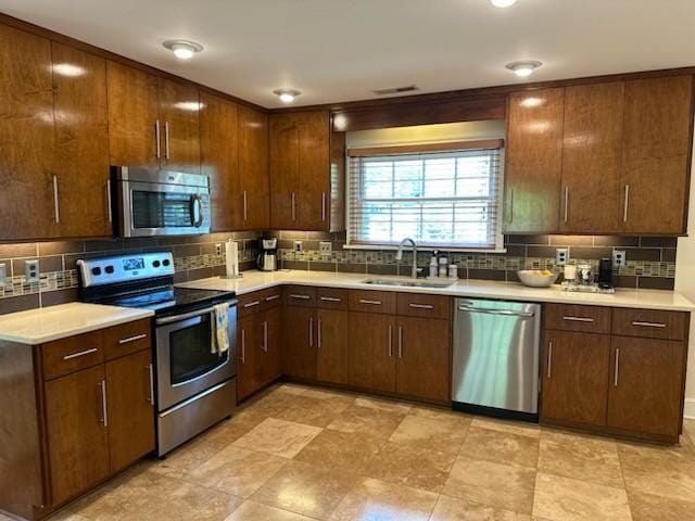 108 Sunset Dr, Pulaski, TN 38478 - kitchen with stainless steel appliances, a sink, backsplash, and light countertops