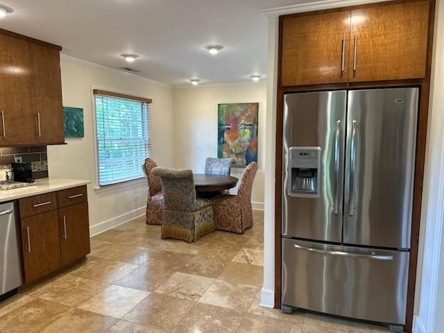108 Sunset Dr, Pulaski, TN 38478 - kitchen featuring stainless steel appliances, baseboards, light countertops, crown molding, and backsplash