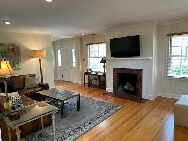 108 Sunset Dr, Pulaski, TN 38478 - living area featuring crown molding, wood finished floors, healthy amount of natural light, and a brick fireplace