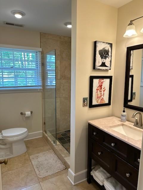 108 Sunset Dr, Pulaski, TN 38478 - full bathroom with a stall shower, toilet, vanity, and baseboards