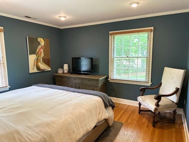 108 Sunset Dr, Pulaski, TN 38478 - bedroom featuring multiple windows, wood finished floors, baseboards, and ornamental molding