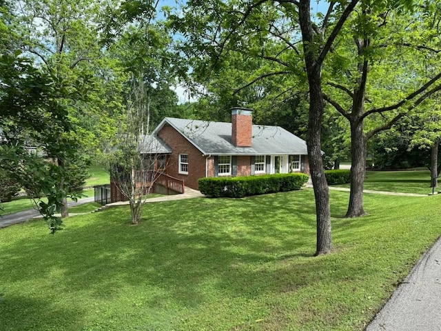 108 Sunset Dr, Pulaski, TN 38478 - view of front of home featuring a chimney, brick siding, a front lawn, and a garage