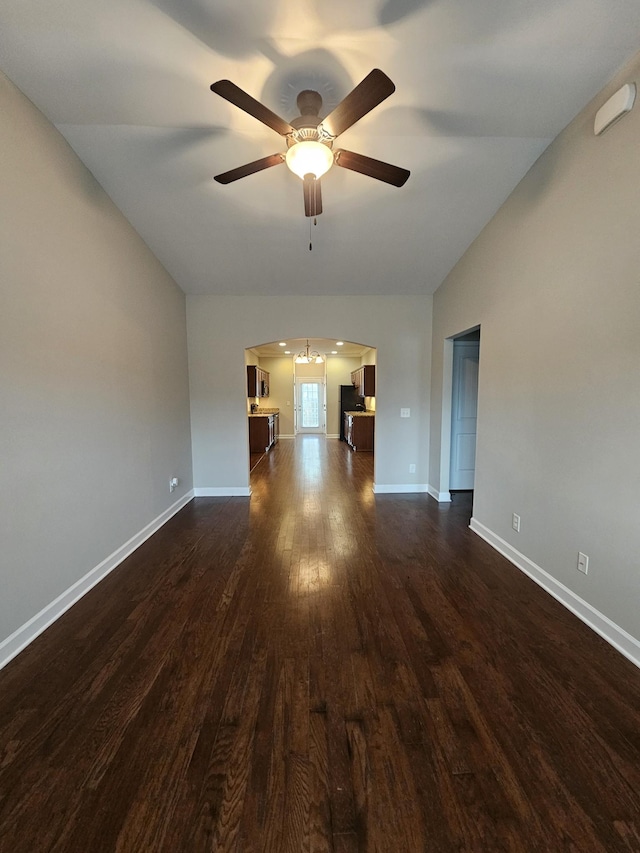 1040 Charlie Daniels Pkwy Unit 111, Mount Juliet, TN 37122 - unfurnished living room featuring arched walkways, lofted ceiling, dark wood-type flooring, a ceiling fan, and baseboards