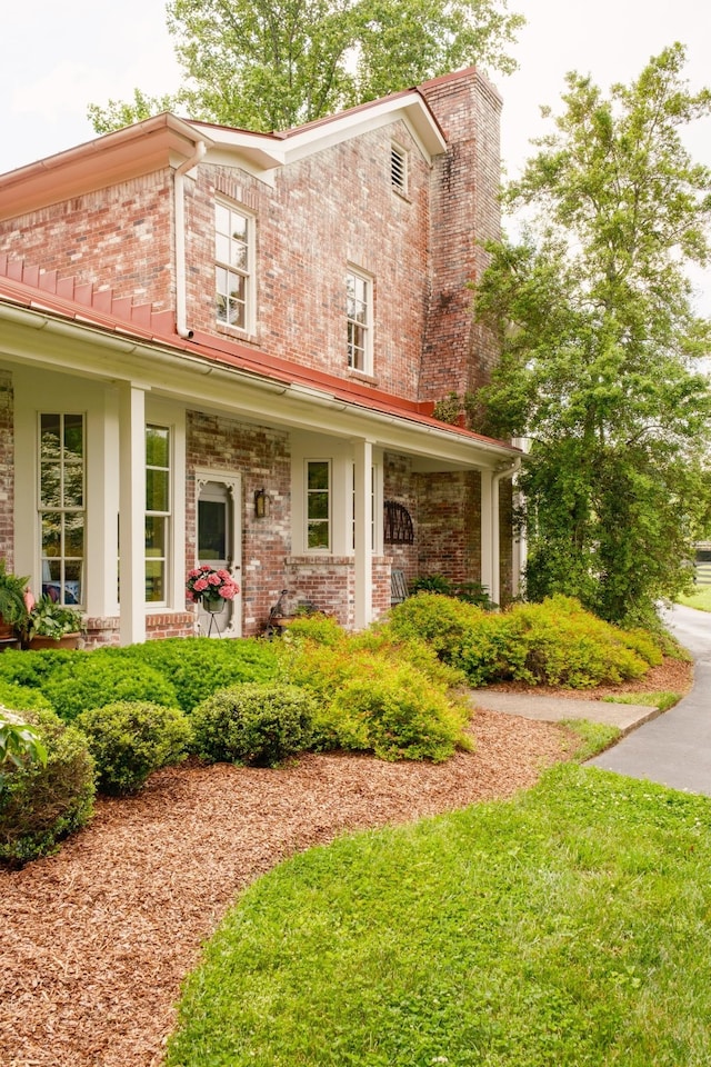 5620 Leipers Creek Rd, Franklin, TN 37064 - view of front of house featuring brick siding, a chimney, and covered porch