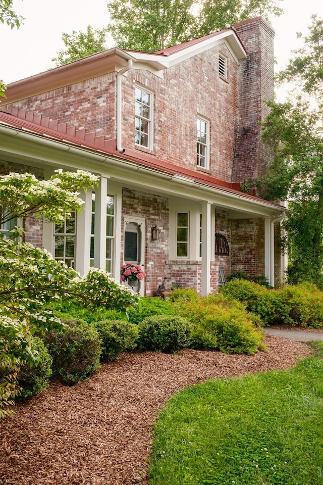5620 Leipers Creek Rd, Franklin, TN 37064 - view of front facade with brick siding, a chimney, and a porch