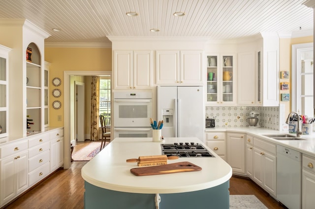 5620 Leipers Creek Rd, Franklin, TN 37064 - kitchen featuring white appliances, a sink, crown molding, dark wood finished floors, and a center island