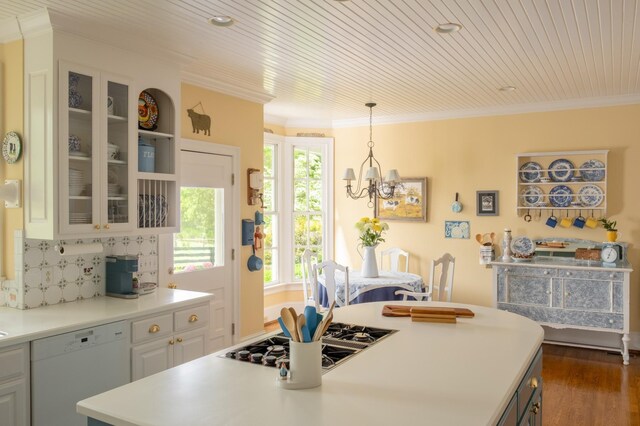 5620 Leipers Creek Rd, Franklin, TN 37064 - kitchen featuring white dishwasher, stovetop with downdraft, dark wood-style floors, glass insert cabinets, and a chandelier