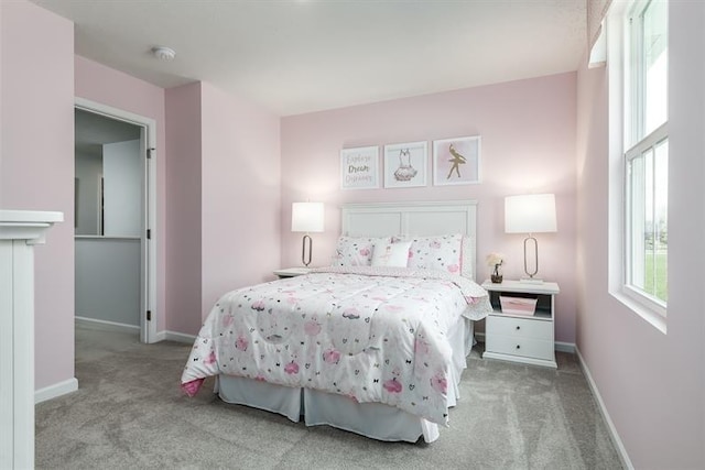 carpeted bedroom featuring baseboards