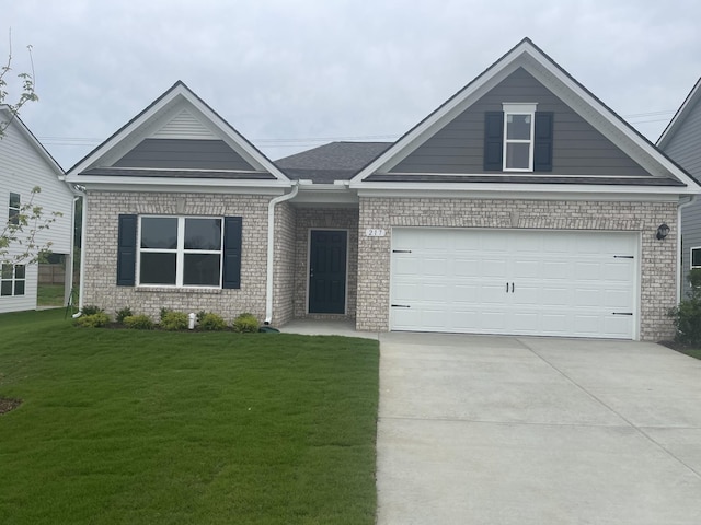 217 Summerlin Dr, Gallatin, TN 37066 - view of front of home featuring concrete driveway, a front lawn, brick siding, and a garage
