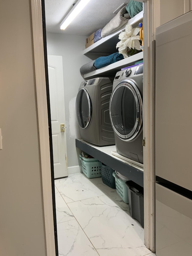 3024 Herman B Rader Dr, La Vergne, TN 37086 - laundry room featuring marble finish flooring and washing machine and clothes dryer