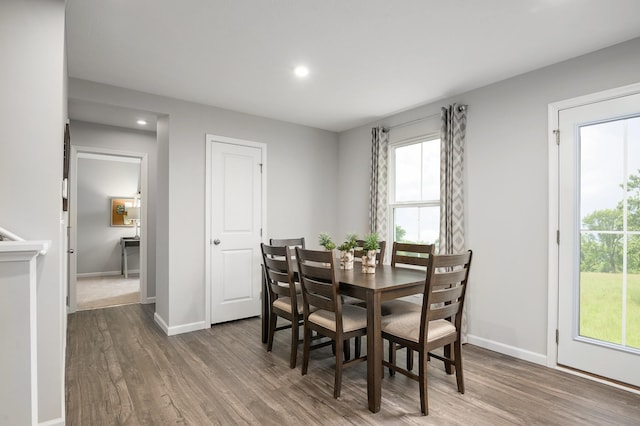 dining room with wood finished floors, recessed lighting, healthy amount of natural light, and baseboards