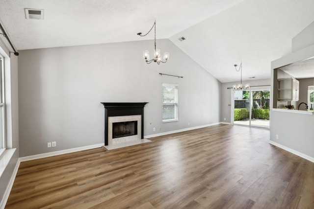 2981 Buckner Ln, Spring Hill, TN 37174 - unfurnished living room featuring a chandelier, a high end fireplace, plenty of natural light, wood finished floors, and high vaulted ceiling