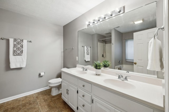 2981 Buckner Ln, Spring Hill, TN 37174 - bathroom with double vanity, toilet, baseboards, and a textured ceiling