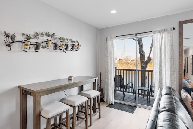 dining area with light wood-style flooring and recessed lighting