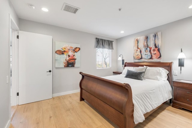 bedroom featuring light wood-type flooring, recessed lighting, and baseboards