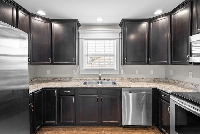 132 Fieldcrest Dr, Cadiz, KY 42211 - kitchen featuring stainless steel appliances, a sink, wood finished floors, light stone counters, and recessed lighting