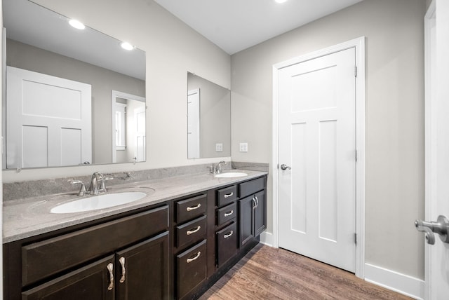 132 Fieldcrest Dr, Cadiz, KY 42211 - full bathroom featuring wood finished floors, double vanity, and recessed lighting