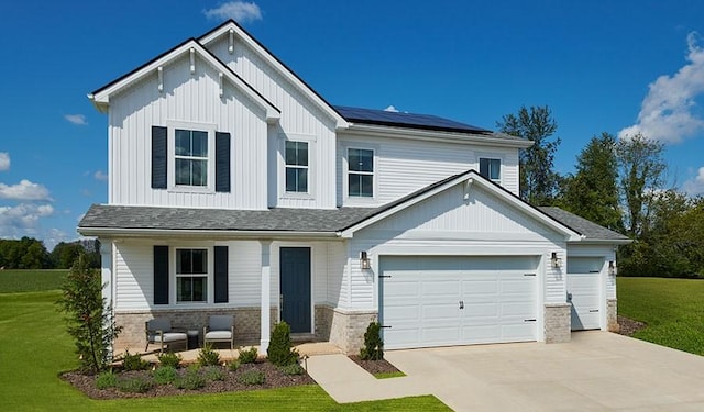 2907 Windstone Trl, Columbia, TN 38401 - view of front facade featuring a front lawn, solar panels, covered porch, and concrete driveway
