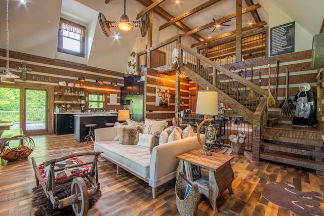 102 Highwater Rd, Waverly, TN 37185 - living room with a high ceiling, stairway, dark wood-style flooring, beamed ceiling, and wood walls