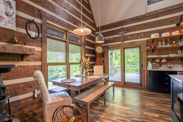 102 Highwater Rd, Waverly, TN 37185 - dining space with wood walls, a high ceiling, and dark wood finished floors