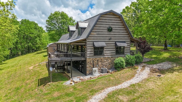 102 Highwater Rd, Waverly, TN 37185 - back of house featuring a lawn, metal roof, a wooden deck, and stone siding