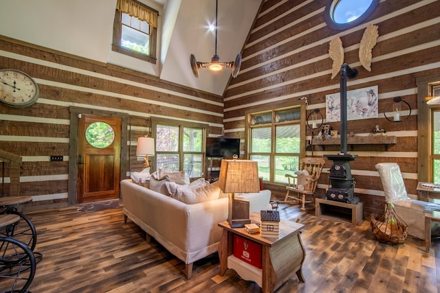 102 Highwater Rd, Waverly, TN 37185 - living area with wood walls, high vaulted ceiling, wood finished floors, and a wood stove