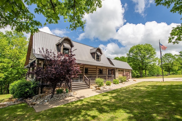 102 Highwater Rd, Waverly, TN 37185 - cabin featuring a porch, metal roof, and a front lawn