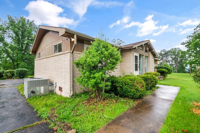 1033 Pine Valley Rd, Kingston Springs, TN 37082 - view of property exterior with cooling unit, brick siding, and a yard