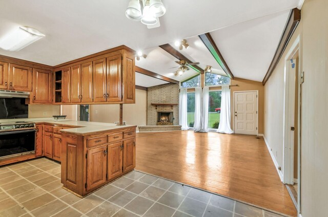 1033 Pine Valley Rd, Kingston Springs, TN 37082 - kitchen featuring electric stove, under cabinet range hood, a ceiling fan, a peninsula, and a fireplace