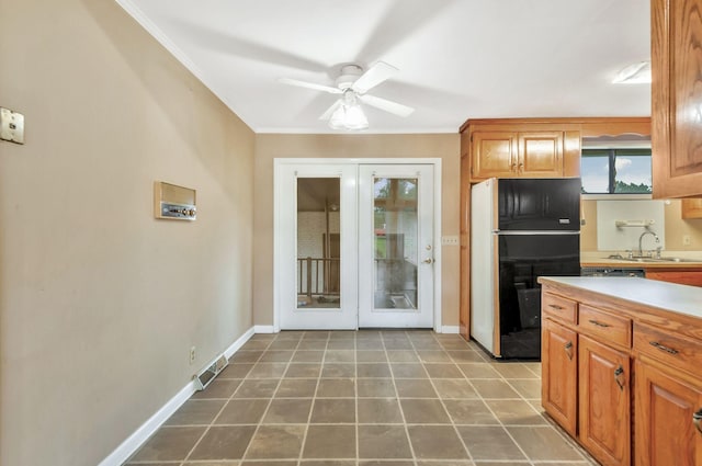 1033 Pine Valley Rd, Kingston Springs, TN 37082 - kitchen with freestanding refrigerator, ornamental molding, a sink, a ceiling fan, and light countertops